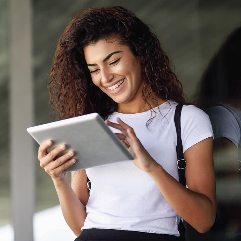 Smiling Woman Using Tablet Device